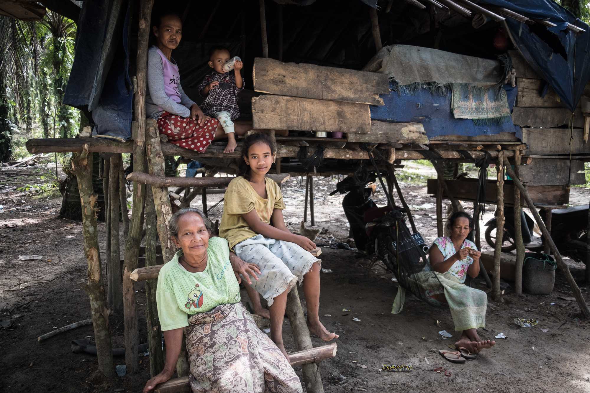 Suku Anak Dalam elder Siti, bottom left, with her family. 