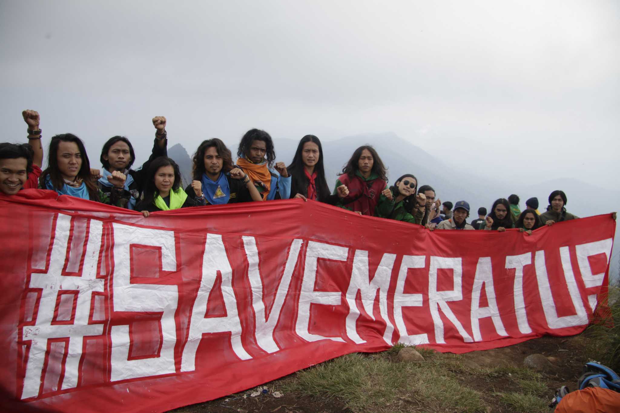 Activists holding a “Save Meratus” banner at the Halau-Halau peak of the Meratus Mountains in Hulu Sungai Tengah Regency.