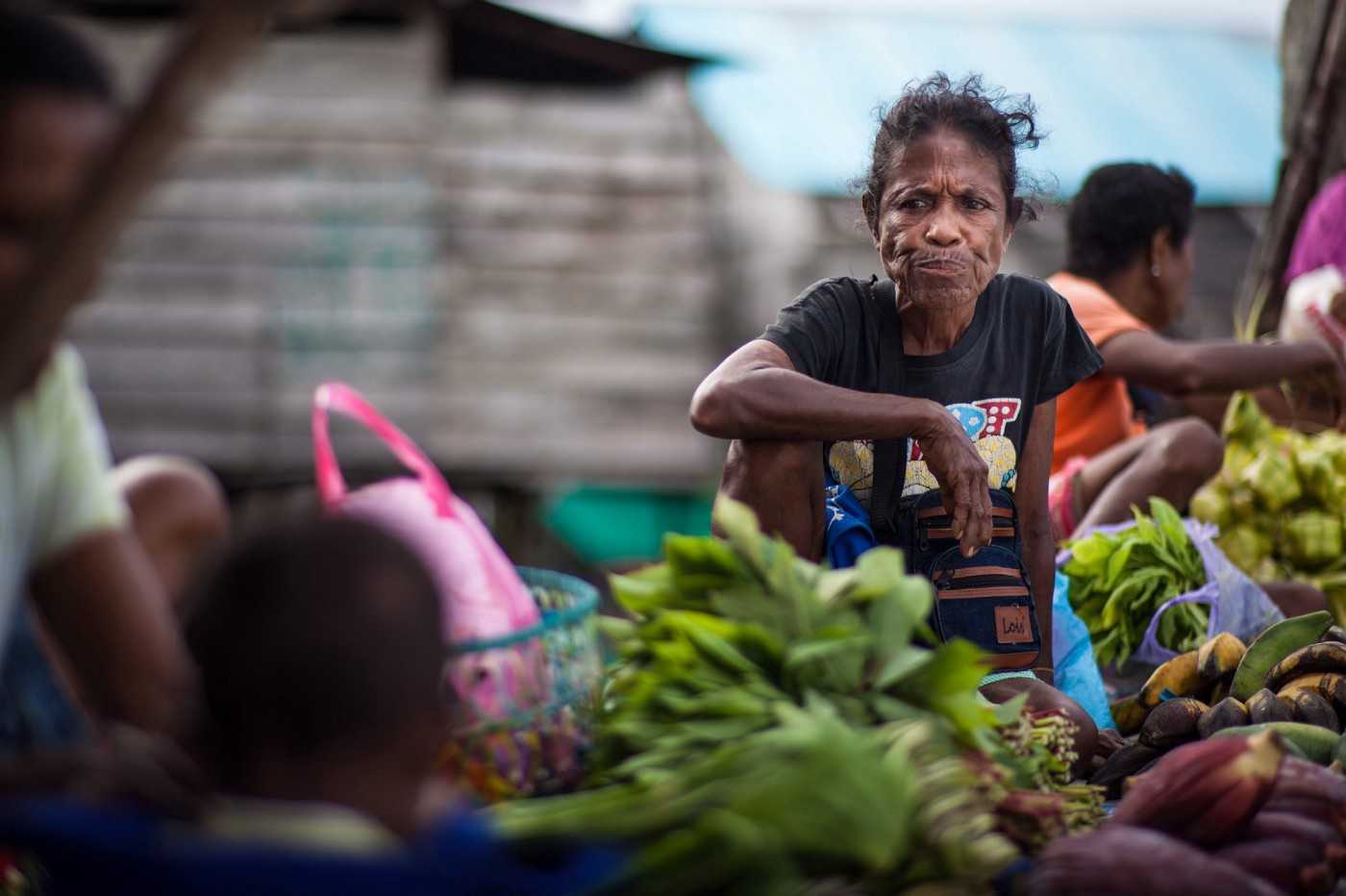 A woman sells vegetables at the market in Dobo, in 2017.
